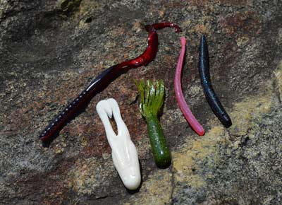 These five soft-plastic lures — ribbon-tail worm, finesse worm, stick worm, tube, and toad — are staples of summertime bass fishing. Every bass angler should have them on hand, from beginner to expert. Photo by Pete M. Anderson
