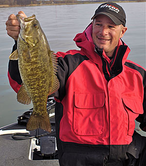 1)	Guide Gerry Gostenik with a typical spring smallmouth caught on a jerkbait.