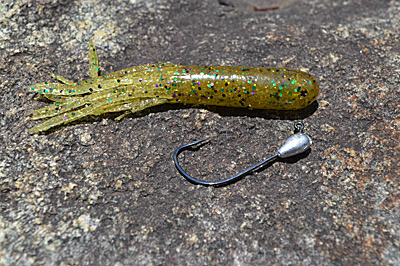 The Stupid Tube preserves the erratic movements of a traditionally rigged tube bait but forgoes the snags that come with an open hook. That allows it to be fished in heavy cover, where big bass lurk. Photo by Pete M. Anderson