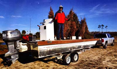 Andrew Niethold adding trees to the lake. Andrew played a critical role in the bass harvesting and fish cover installation efforts, alongside David White.