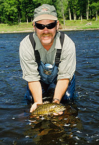 Dan Donarski with a river smallmouth caught during summer.