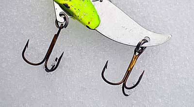 Improve your blade bait’s hooking power by switching to a round bend treble with a short shank. The added space between point and shank helps them grab quickly and more often, and their length keeps them away from snags. Photo by Pete M. Anderson