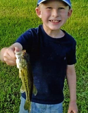 A big smile after catching his first largemouth bass. 