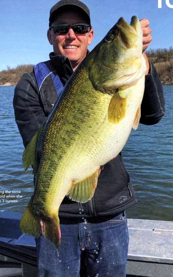 Dave Beasley holding the same bass at 48 months old when she weighed 14 pounds 3 ounces.