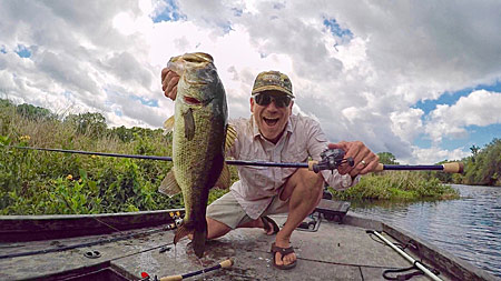 2)	Joe Balog with a chunky Florida largemouth he was able to wench from cover with a more powerful, longer rod.