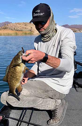 The author with a chunky smallmouth caught during a tough bite in the desert southwest.