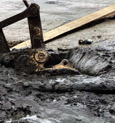 A trackhoe was used to help determine the depth of silty areas.