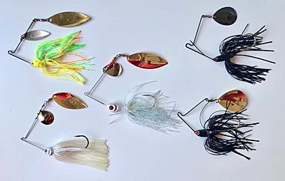 An assortment of basic spinnerbaits: chartreuse for cloudy days, black for night or muddy water, white or baitfish color for bright days.