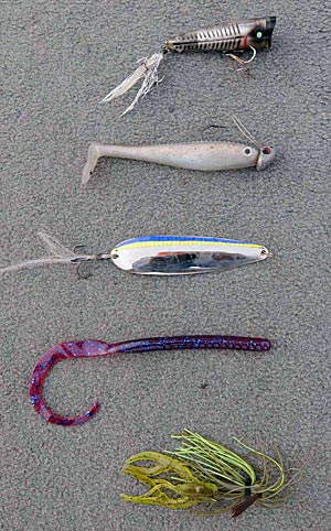 Dion Hibdon’s five favorite lures for summertime bass are (from top) a topwater popper, swimbait, flutter spoon, plastic worm and jig with a soft plastic trailer.