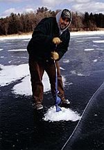 Students use ice augers to drill holes to check water quality under the ice.