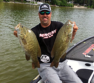 Mark Zona is holding to Michigan smallmouth that fell victim to his super sneaky Strike King Fat Baby Finesse Worm. Photo Credit:  Zona’s Awesome Fishing Show
