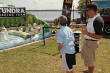 Chip Porch helps a young angler sharpen his casting skills in the Toyota booth.